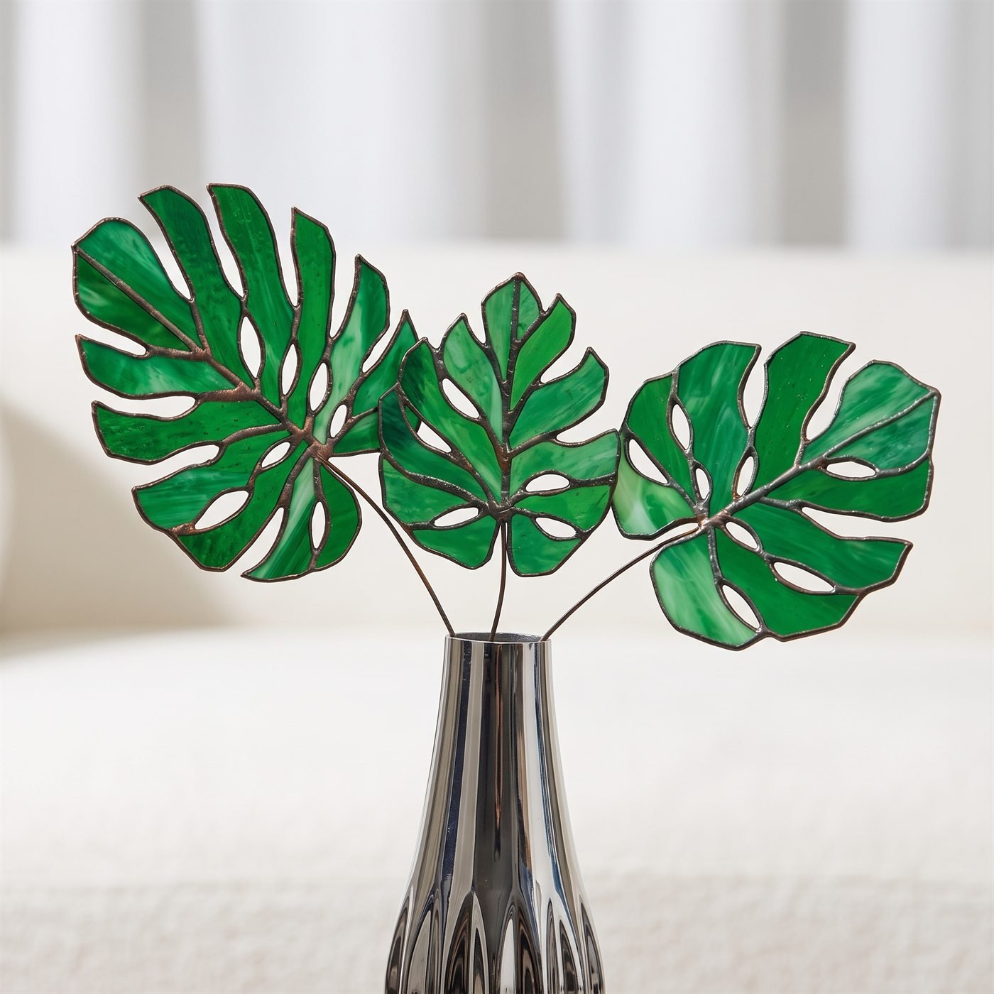 Close-up detail – Stained-glass monstera leaves · silver vase